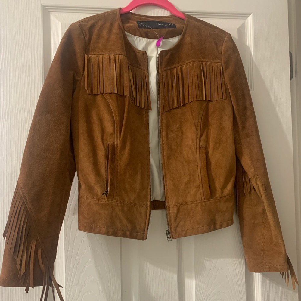 100% leather brown fringe jacket. Lining is polyester/cotton. Worn only once